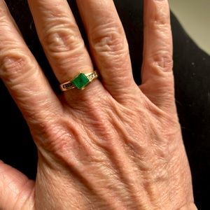Gorgeous genuine emerald ring with diamond accent stones.